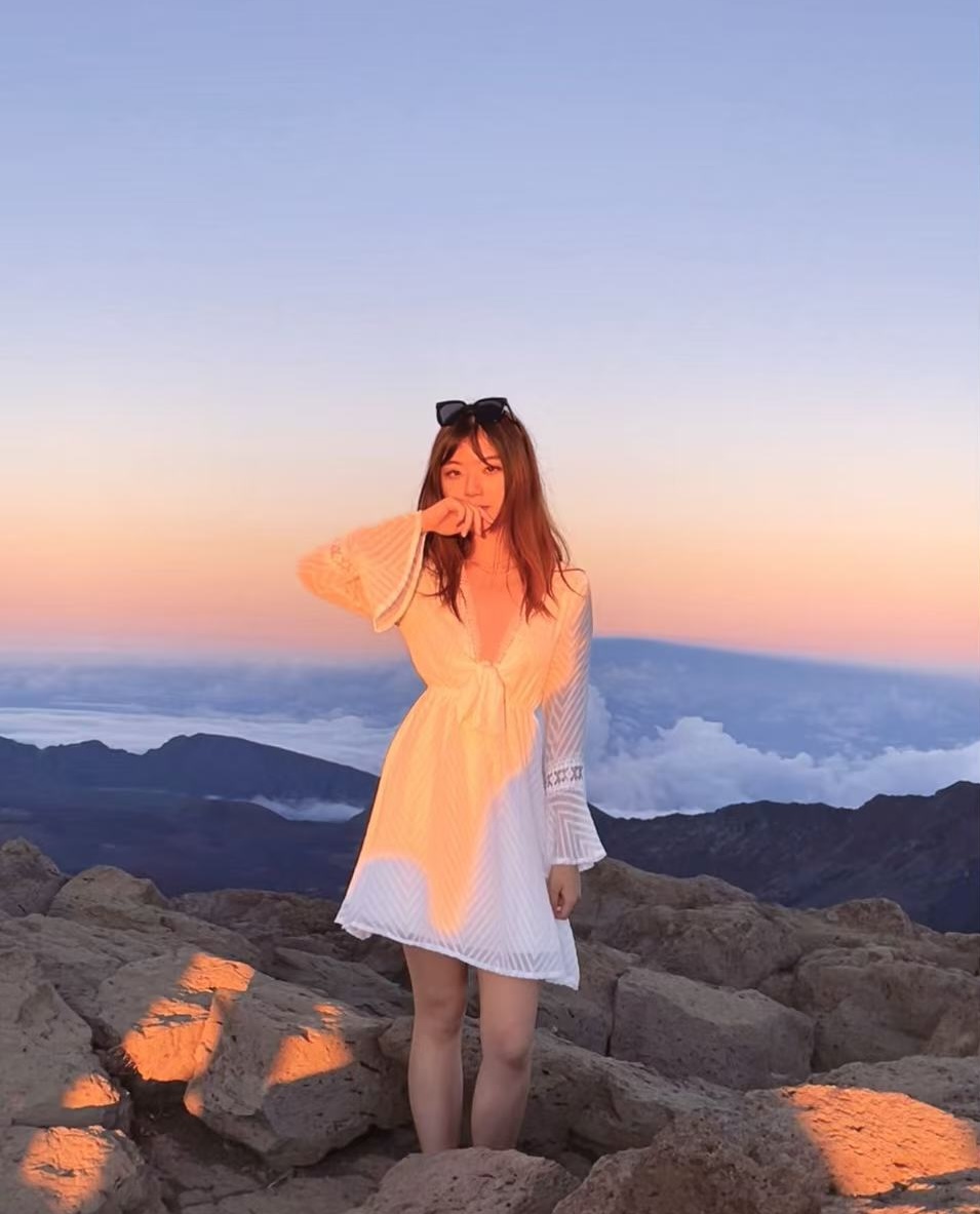 Nancy Xing at sunset above the clouds